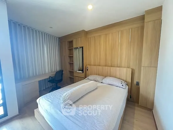 Modern bedroom with wooden accents and built-in desk, perfect for a cozy and functional living space.
