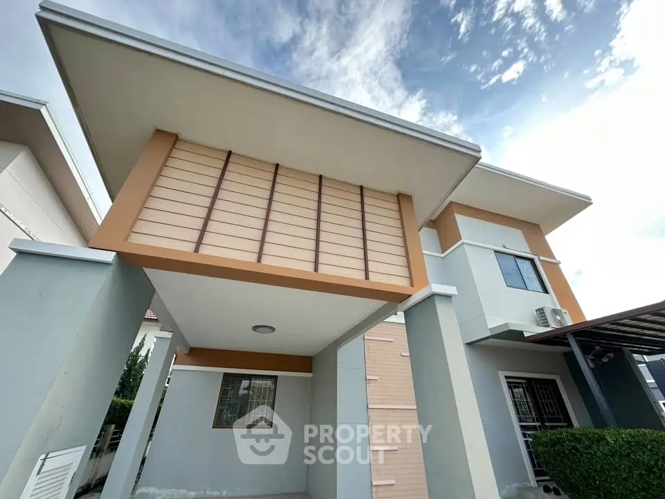 Modern two-story house with unique architectural design and spacious exterior.