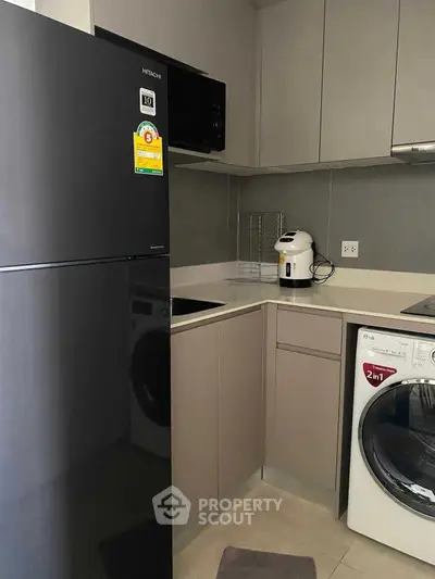 Modern kitchen with sleek appliances and compact design