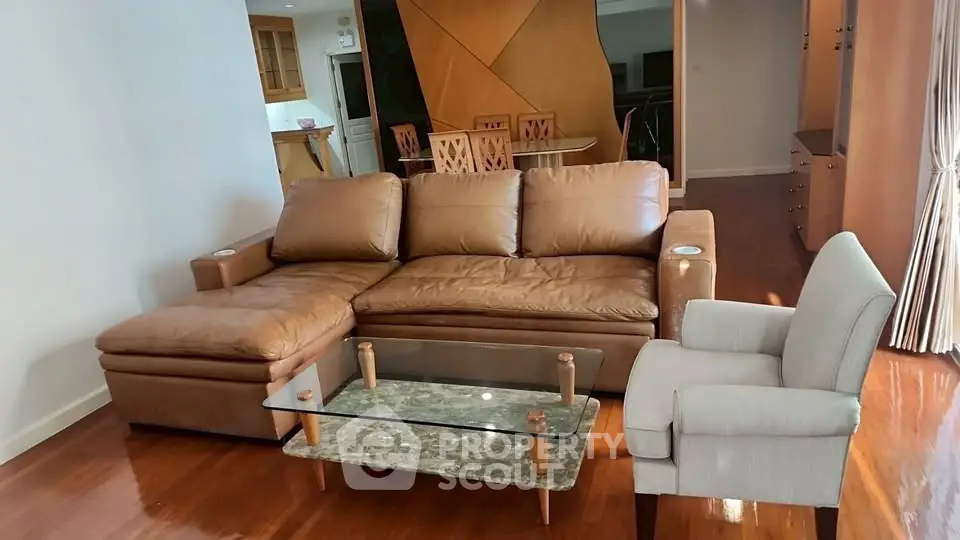 Spacious living room with elegant leather sofa and modern glass coffee table