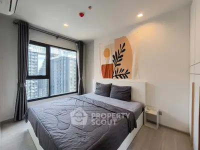 Modern bedroom with large window and stylish decor in high-rise apartment