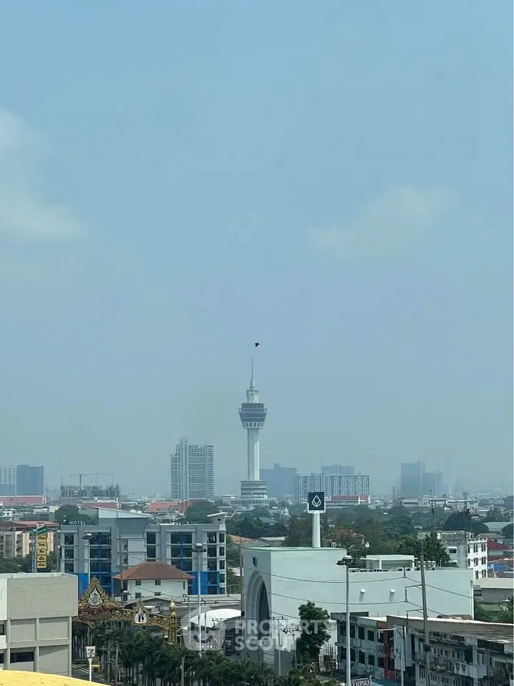 Stunning cityscape view featuring iconic tower and urban skyline, perfect for real estate investment.