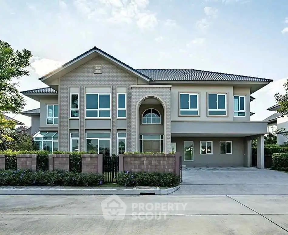 Elegant two-story house with modern architecture and spacious driveway.