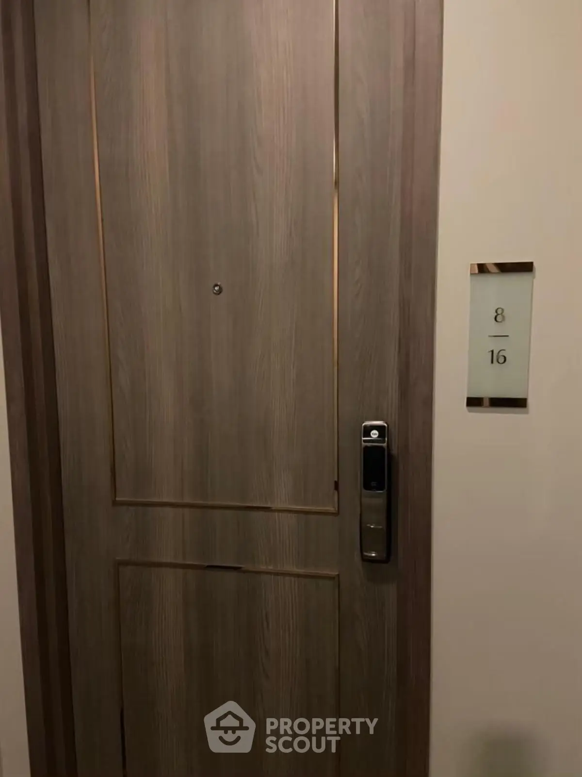 Modern apartment door with electronic lock and room number 8/16