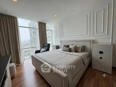 Luxurious bedroom with city view, elegant decor, and large windows in modern apartment.