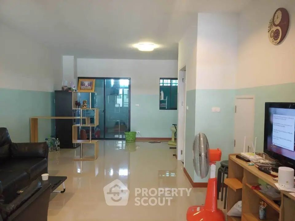 Spacious living room with modern decor and ample natural light