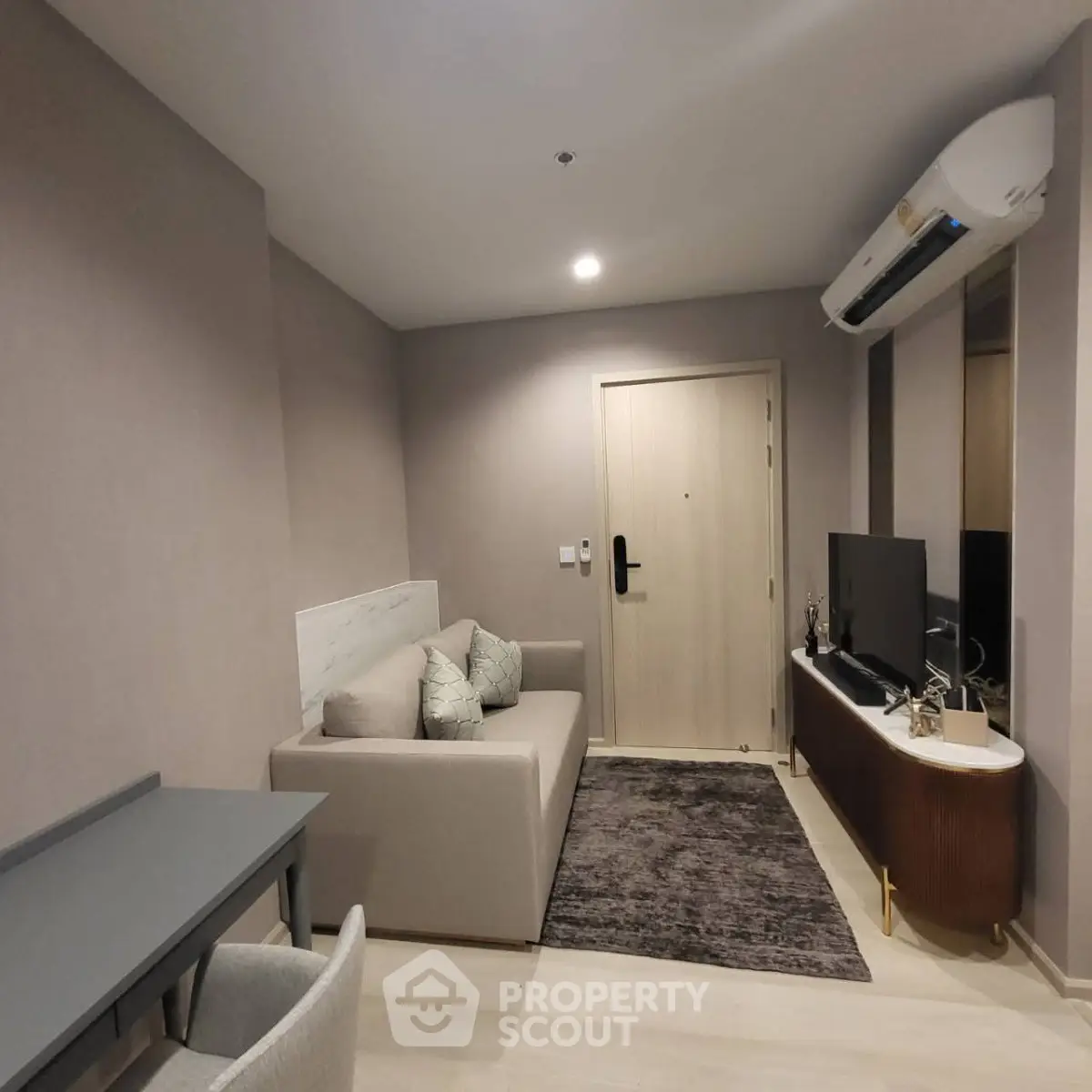 Modern living room with sleek furniture and air conditioning in a stylish apartment.