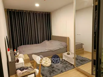 Cozy bedroom with modern decor, mirrored wardrobe, and stylish furnishings in a contemporary apartment.