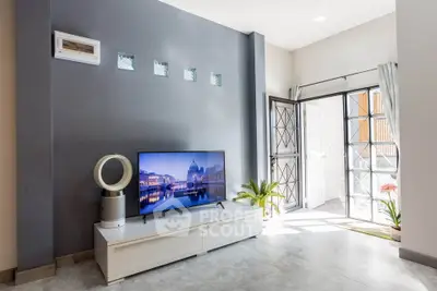 Modern living room with sleek TV setup and natural light