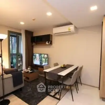 Modern living room with dining area and air conditioning in a cozy apartment.