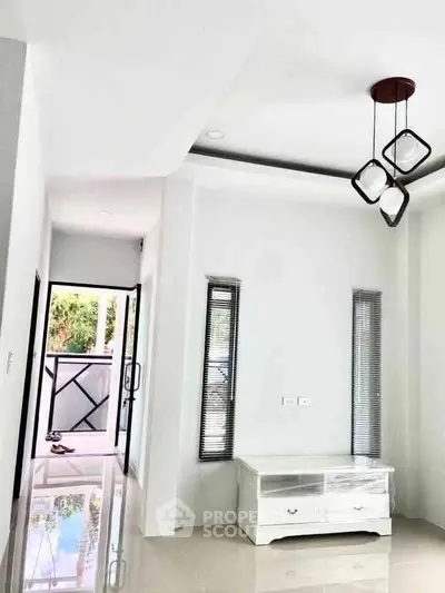 Modern living room with sleek lighting and balcony access, featuring minimalist decor and glossy flooring.