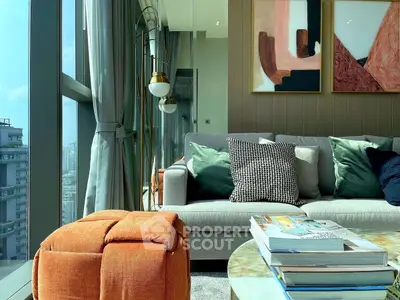 Modern living room with stylish decor and large windows offering city views.