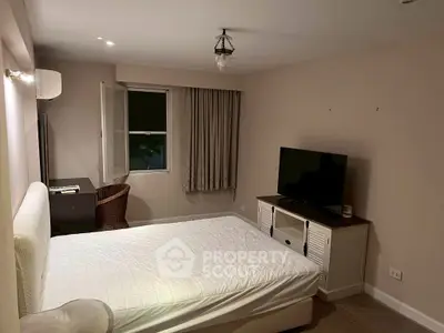 Cozy bedroom with modern furnishings and natural light, perfect for relaxation.