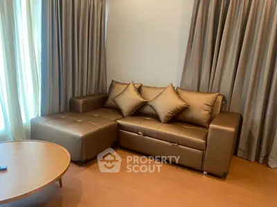Luxurious living room with elegant brown leather sofa and stylish wooden coffee table.