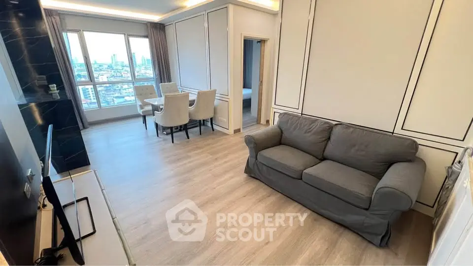 Modern living room with city view, elegant dining area, and cozy sofa in a stylish apartment.