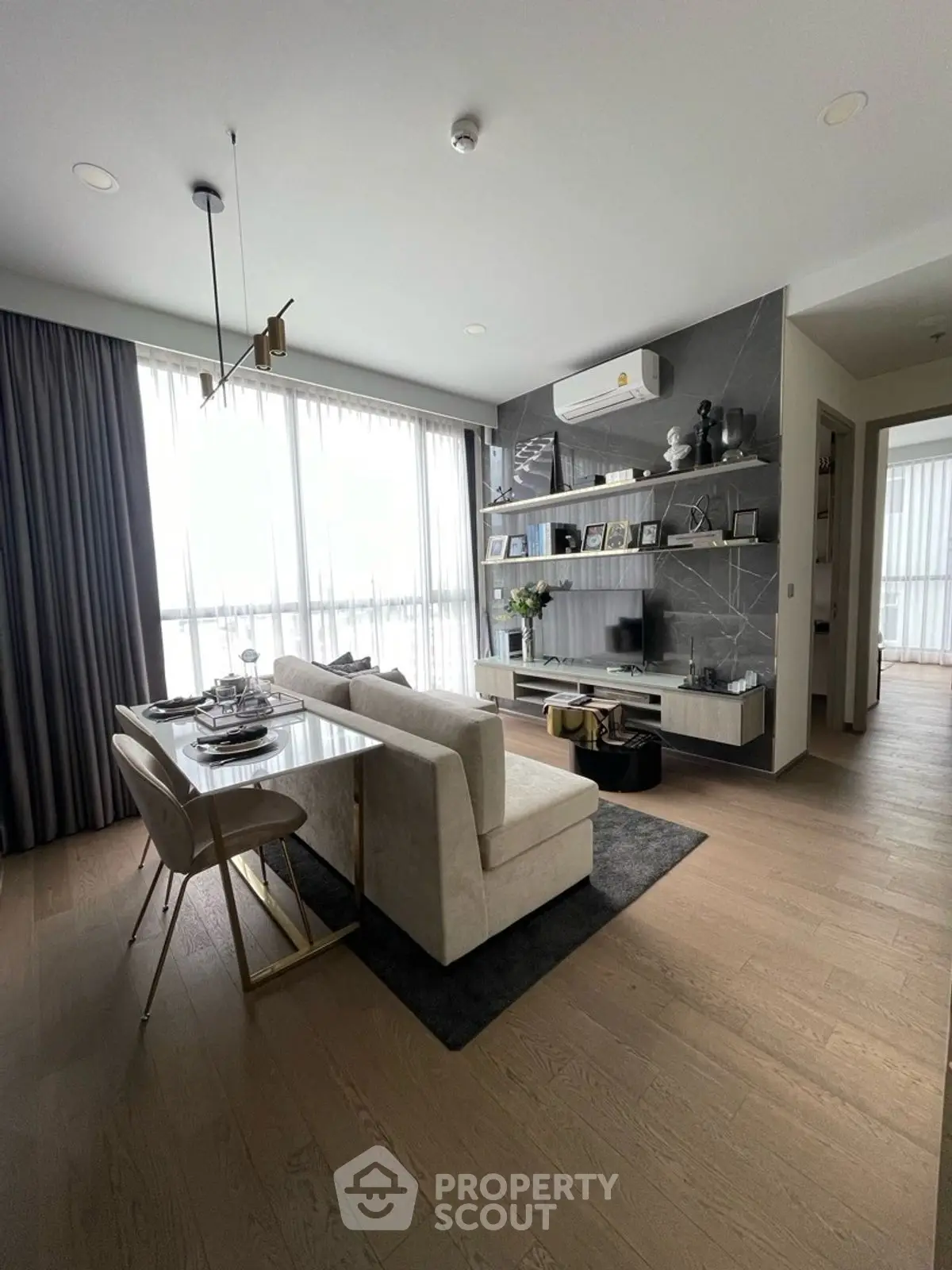 Modern living room with elegant decor and large windows for natural light.