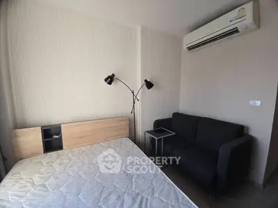 Modern bedroom with air conditioning and stylish lighting in a cozy apartment.