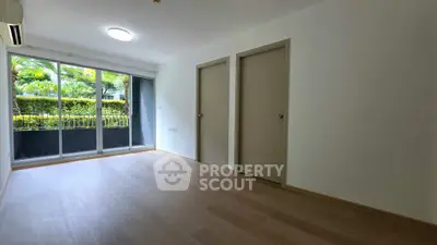 Spacious empty room with large windows and garden view, perfect for customization.