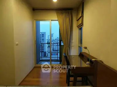 Cozy bedroom with city view and balcony access in modern apartment