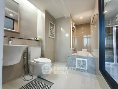 Modern bathroom with sleek fixtures and a luxurious bathtub in a contemporary apartment.