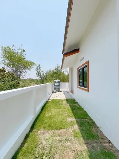 Spacious balcony with lush greenery view and modern exterior design
