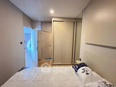 Modern bedroom with sleek wardrobe and cozy bed in stylish apartment.