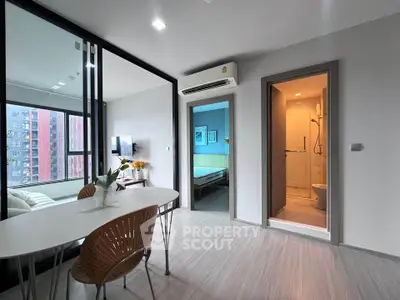 Modern apartment interior with open living area and bathroom, featuring sleek design and natural light.