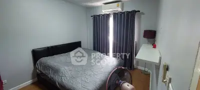 Cozy bedroom with modern decor, featuring a comfortable bed, air conditioning, and natural light through curtains.