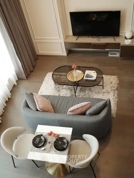 Elegant living room with modern decor, cozy seating, and stylish dining area.