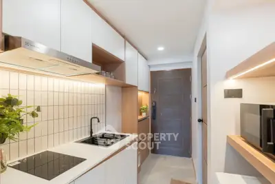 Modern kitchen with sleek design and built-in appliances in a compact layout.