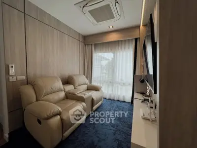 Cozy living room with plush leather recliners and modern decor, perfect for relaxation.