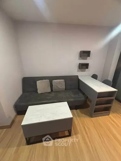 Modern living room with sleek furniture and wooden flooring, perfect for cozy gatherings.