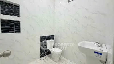 Modern bathroom with sleek white tiles and stylish black accents