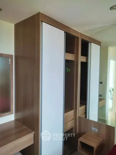 Modern wooden wardrobe with sliding doors in a stylish bedroom interior