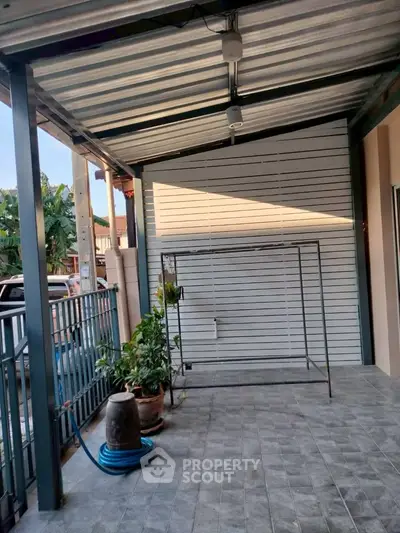 Spacious covered patio with tiled flooring and garden view