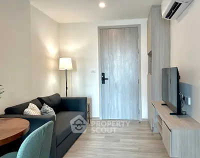 Modern living room with sleek furniture and natural light, perfect for cozy relaxation.