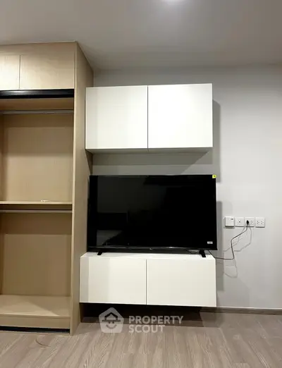 Modern living room with sleek TV setup and stylish cabinetry