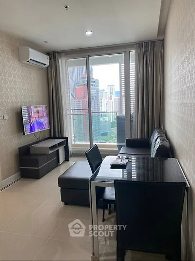 Modern living room with city view, sleek furniture, and natural light in a high-rise apartment.