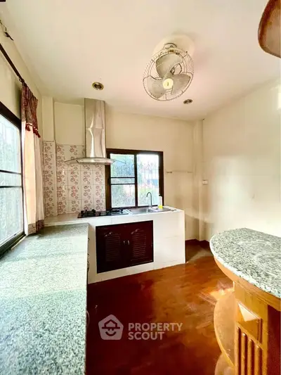 Charming kitchen with ample natural light and modern appliances