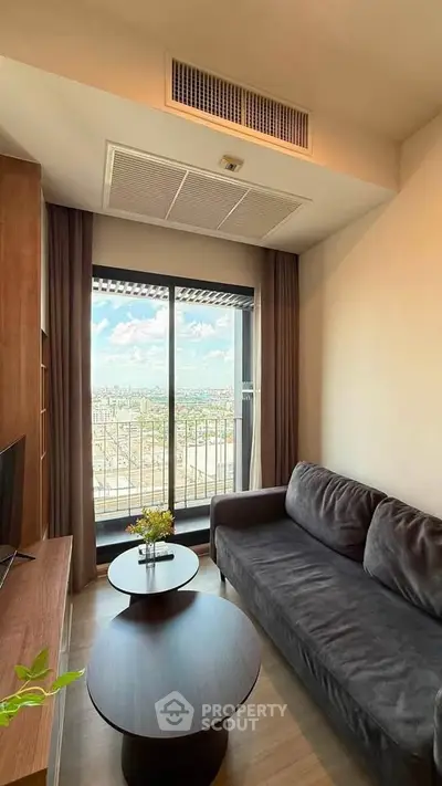 Stylish living room with cozy sofa and stunning city view from balcony.