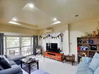 Spacious living room with modern decor and large windows for natural light.