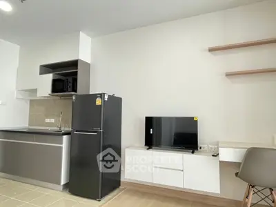 Modern kitchen with sleek appliances and minimalist design in a stylish apartment.