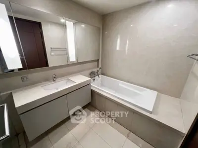 Luxurious modern bathroom with sleek design and elegant bathtub.