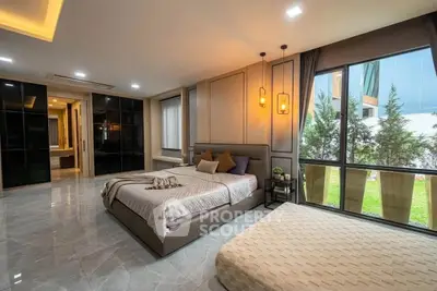 Luxurious modern bedroom with large windows and elegant decor