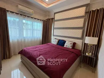 Luxurious bedroom with elegant decor and large windows