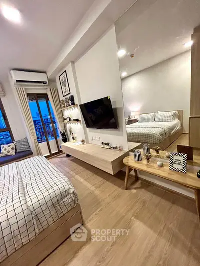Modern bedroom with stylish decor, large mirror, and cozy ambiance in a contemporary apartment.