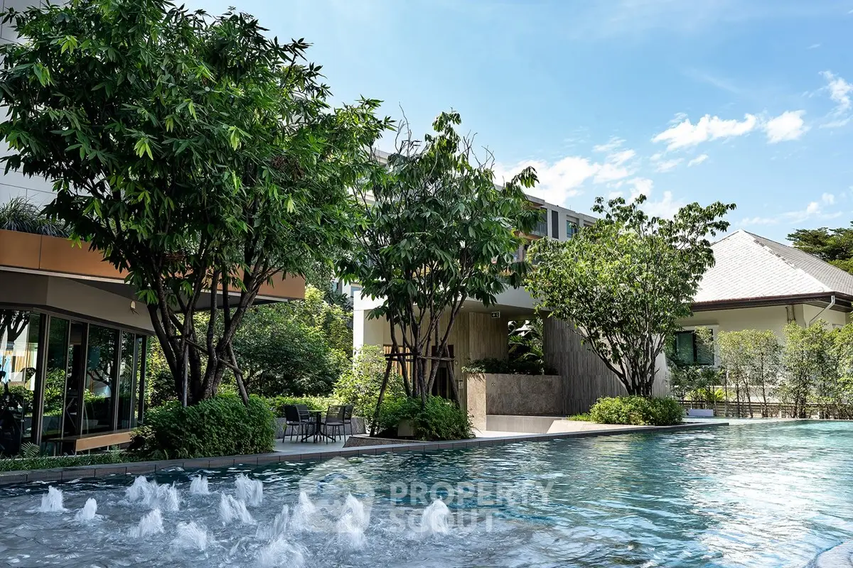 Luxurious residential pool area with lush greenery and modern architecture