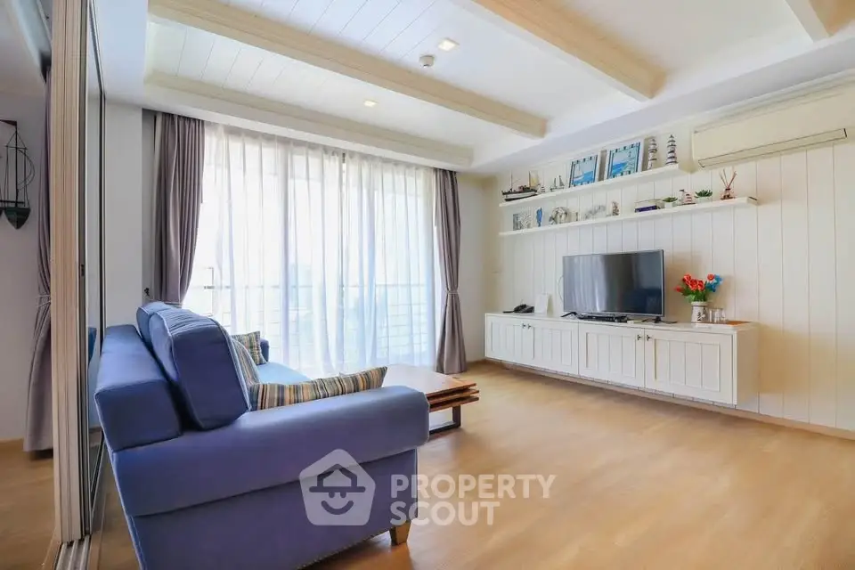 Spacious living room with modern decor and large windows for natural light.