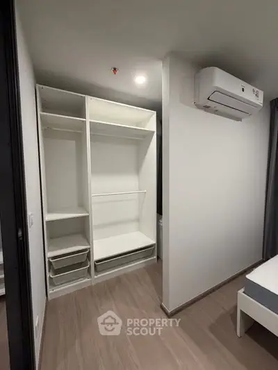 Modern bedroom with open closet and air conditioning unit