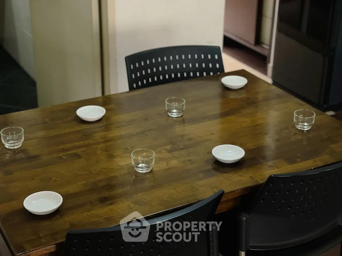Elegant dining table with modern chairs set for a cozy meal.